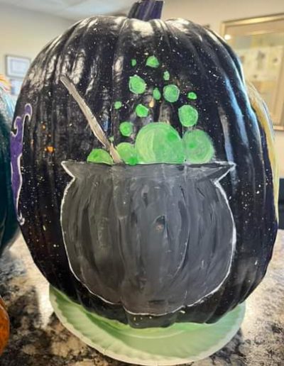 A Picture of a Cauldron Painted Pumpkin