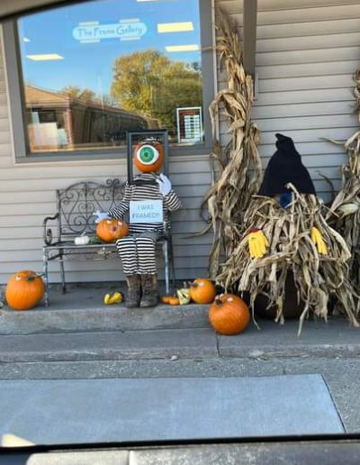 A Picture of Scarecrow with Pumpkin Head and Fall Decor