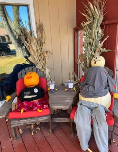 A Picture of 2 Scarecrows with Pumpkin heads